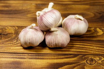 Bulbs of garlic on wooden table