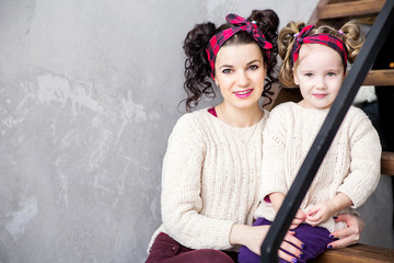 mother and daughter sitting together on the steps