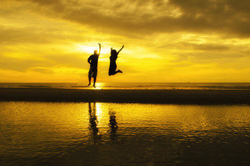 Silhouette of people at the beach in the evening.