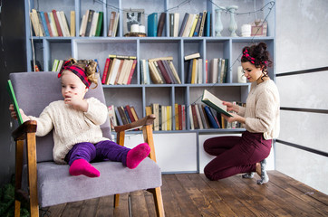 Mom and daughter together on the second floor of a house in the library