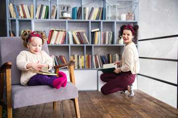 Mom and daughter together on the second floor of a house in the library