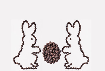 Easter bunny from coffee beans with egg on a white background
