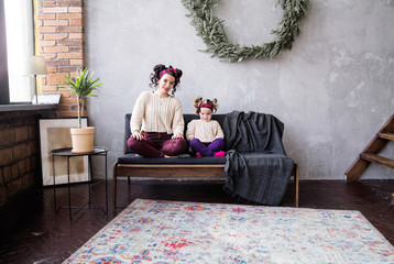 Mom and daughter together at home on the couch