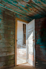 Obraz na płótnie Canvas open entrance, old, with peeling paint, a wooden front door to the house