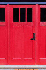entrance, red, wooden door with black glass windows and metal handle
