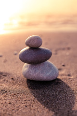 Fototapeta na wymiar stack of stones over beach at sunset. Zen concept