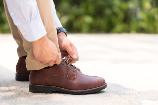 Businessman With Leather Shoes Tying Shoe Laces, Get Ready To Work Or Go Outside