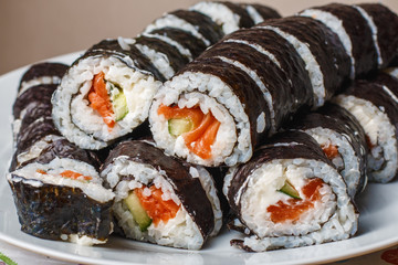 rolls with salmon, cucumber and cheese