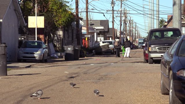 People walk on the street in an african american neighborhood in New Orleans, Louisiana.
