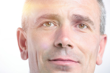 Portrait of successful mature business man smiling against white