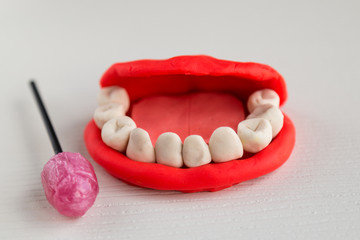 dental care. make teeth with play dough . rotten tooth concept. dentist concept. candy rotates...