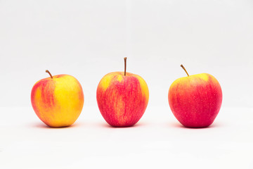 three red apples on a white background