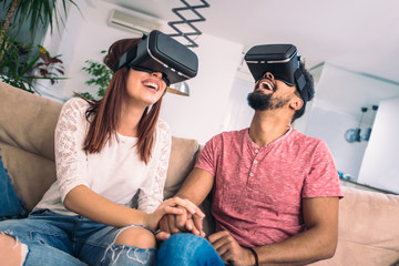 Young man and woman in casual clothes wear the virtual reality glasses are watching and showing imagine via the VR camera, Technology and innovation concept