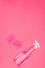 top view of pink washing sponges and spray bottle isolated on pink