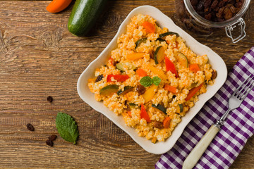 Millet with vegetables and raisins.