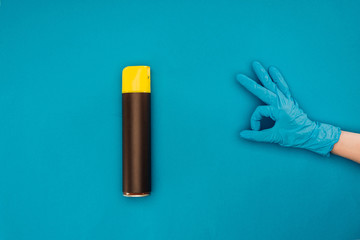 cropped image of woman showing ok sign near spray bottle isolated on blue