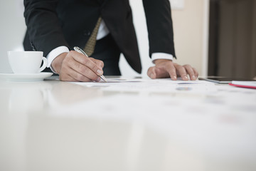 Hand of businessmen write business document charts at office desk. He are analyzing. brainstorming concept..