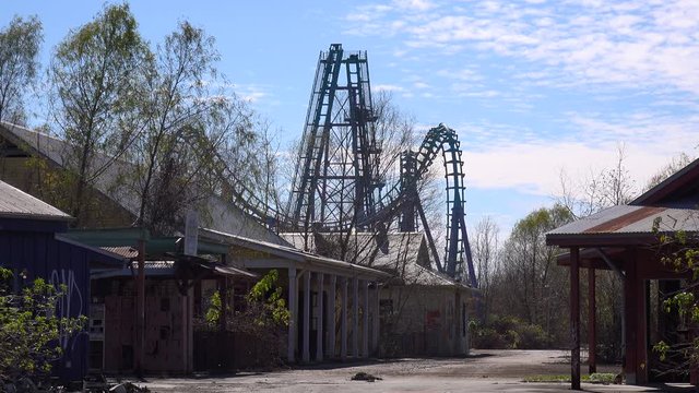 A roller coaster at an abandoned amusement park presents a spooky and haunted image.