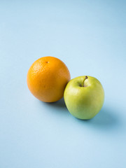 Fresh fruit Apple orange isolated on blue background