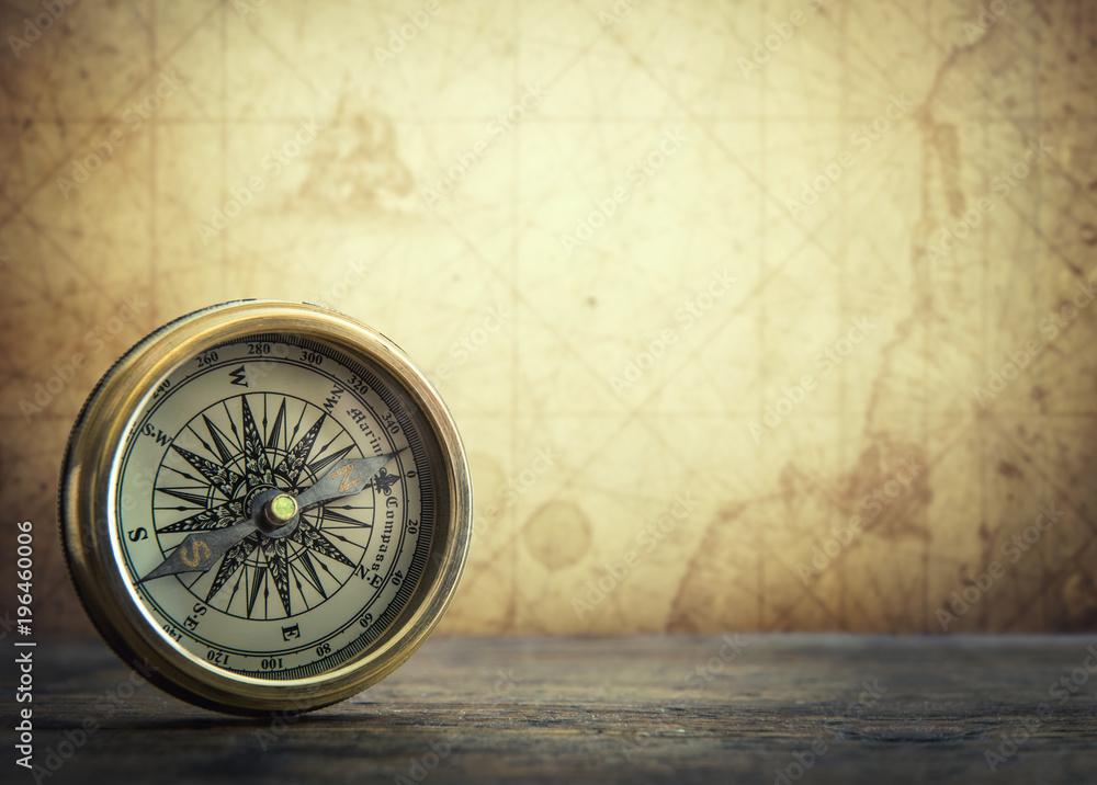 Poster old vintage retro compass on ancient map background. travel geography navigation concept background.