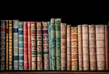 Old books on wooden shelf. 