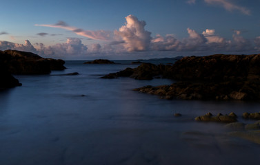 Serinity view of sunset seascape with natural coastal rocks on the beach.