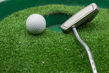 Golf ball is on green grass