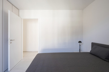 Front view of bedroom in modern apartment