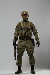 Full-length image of soldier in camouflage with gun