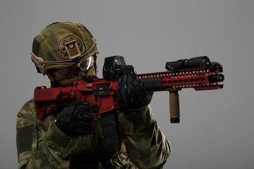 Picture of aiming military man in helmet with gun