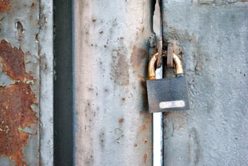 Iron door and with hanging padlock, private territory zone border, horizontal background