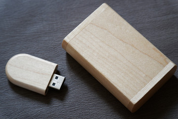 Usb flash drive with wooden surface in wooden box on desk for USB port plug-in computer laptop for transfer data and backup business concept