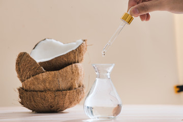 Healthy skincare. Pure coconut oil is made from organic coconut on wooden background