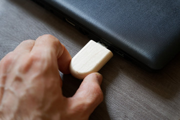 Hand inserting USB flash drive connect to USB port plug-in computer laptop for transfer data and backup business concept