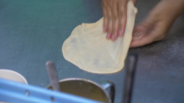 Banana pancake fried in hot pan in Thailand, Rotee of street food. 4k