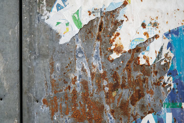 Torn poster after vote on tin textured wall. Ripped newspaper
