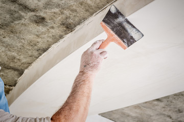 manual worker with wall plastering tools