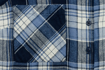 Blue checkered fabric close-up. Part of shirt.  Pocket and buttons. Texture