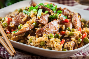 Fried rice with chicken and vegetables served on a plate