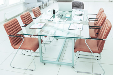  Desk for negotiations with the prepared financial charts and office equipment in the conference room before business meetings.