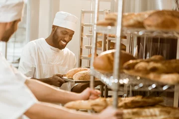 Foto op Plexiglas handsome bakers working together at baking manufacture © LIGHTFIELD STUDIOS
