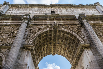 Obraz premium Roman Forum, The Arch of Septimius Severus in Rome. The Triumphal Arch of Emperor Septimius Severus, Roman forum, Rome, Italy. 