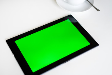 Black tablet pc with green screen. Chroma key.