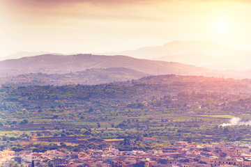 Scenic view of the city and the mountains on a sunny day