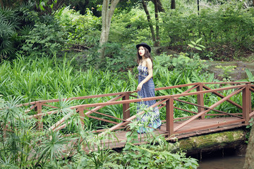 Closeup Shot of A Beautiful Lady in Blue Dress Posing on A Wooden Bridge in A Forest of Mae Hong...