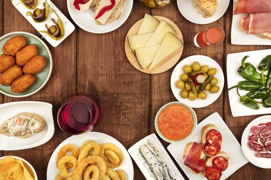 The food of Spain. Overhead photo of many different Spanish tapas with wine and copy space