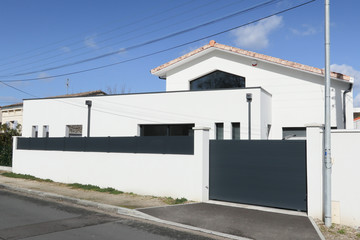 Fototapeta na wymiar Facade and entry to a contemporary white rendered home