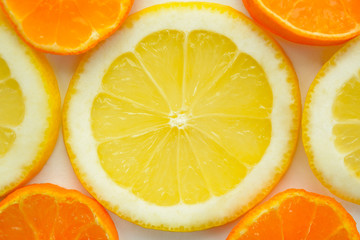 Naklejka na ściany i meble Background from slices of lemons and mandarin