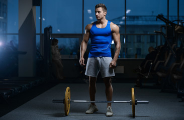 Fototapeta na wymiar Handsome model young man workout in gym