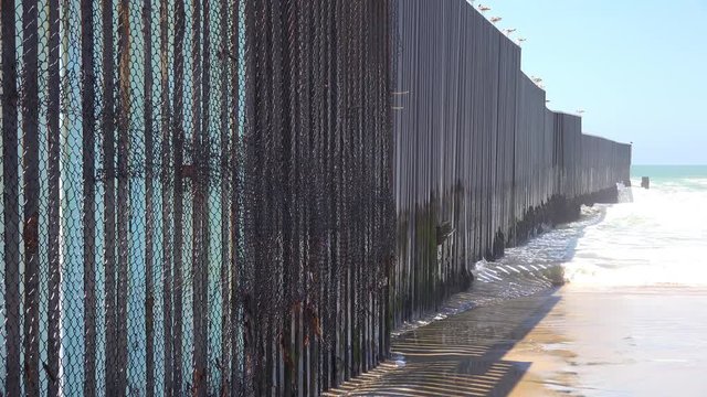 Waves roll into the beach at the U.S. Mexico border fence in the Pacific Ocean between San Diego and Tijuana.